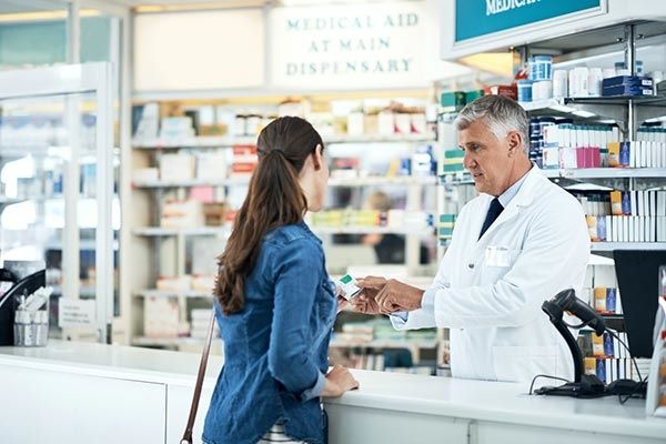 A patient being helped by a pharmacist